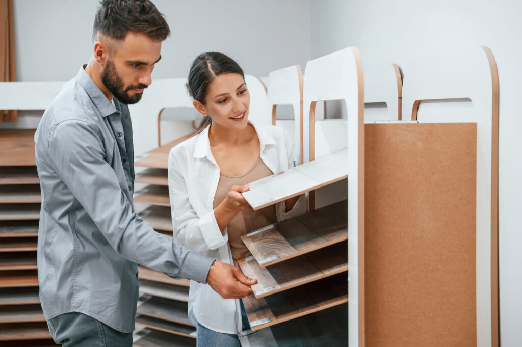 Quality wood. Woman and man is in the store of goods for the home